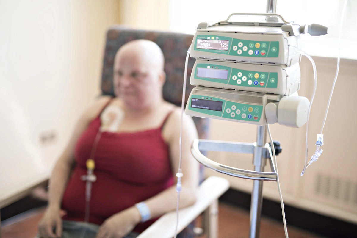 woman in hospital chair suffering from cancer