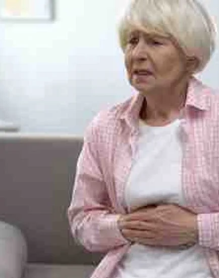 Senior woman suffering from epigastria pain, health problems in old age