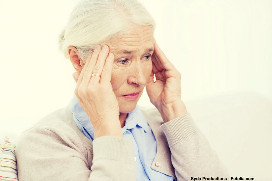 face of senior woman suffering from headache