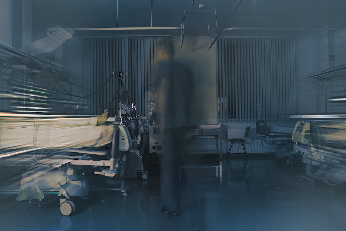 Medical doctor figure blurred in motion on the night shift in the critical care unit