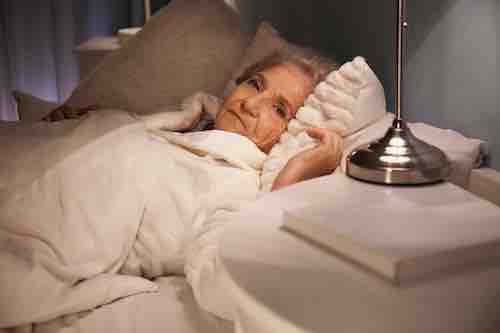 Senior woman suffering from insomnia at night