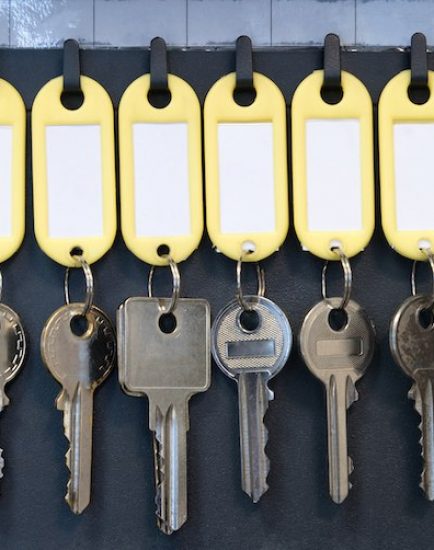 Hanging keys in metal cabinet for safety office or household keys management and keeping. keys with blank name tags, space for text