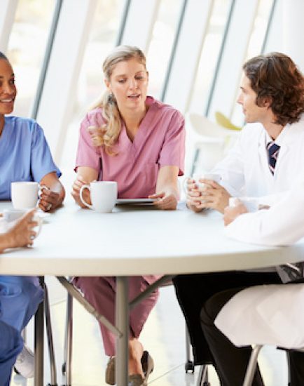 Medical Staff Chatting In Modern Hospital Canteen