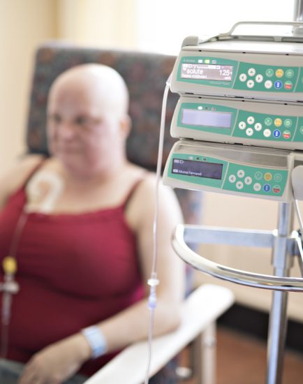 woman in hospital chair suffering from cancer