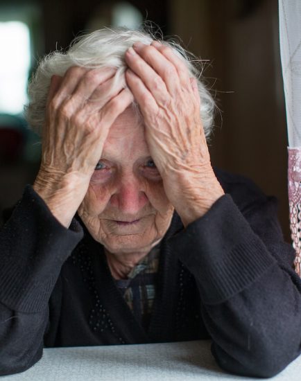 An elderly woman in a state of depression.