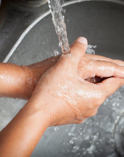 Woman washing her hands under running water