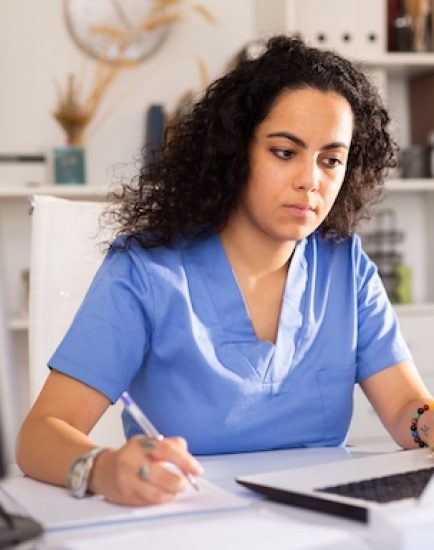 Portrait of female doctor working on laptop computer consulting patient online, telemedicine concept